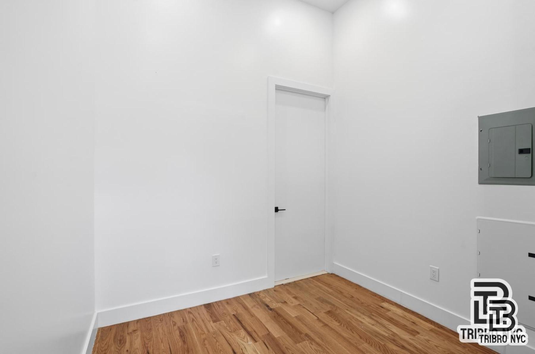 1112 Fulton Street, Unit 1 Brooklyn, NY 11238 - Photo 8 of 9 a view of a room with wooden floor