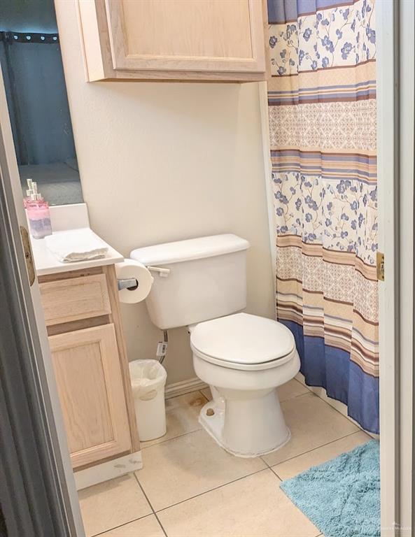 109 East Retama Street, Unit 1 South Padre Island, TX 78597 - Photo 11 of 16 a bathroom with a toilet and a shower curtain