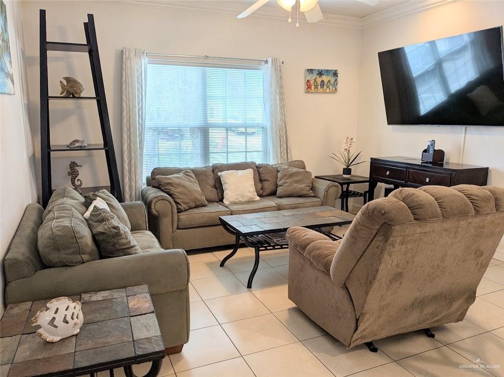 109 East Retama Street, Unit 1 South Padre Island, TX 78597 - Photo 3 of 16 a living room with furniture and a flat screen tv
