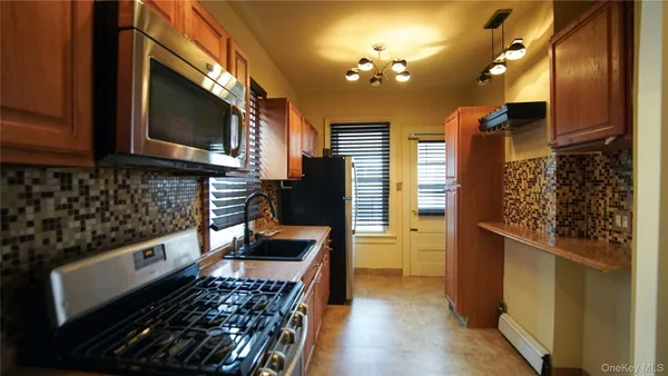a kitchen with wooden cabinets and a stove top oven