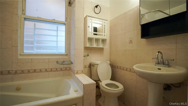 a bathroom with a sink a toilet and bathtub