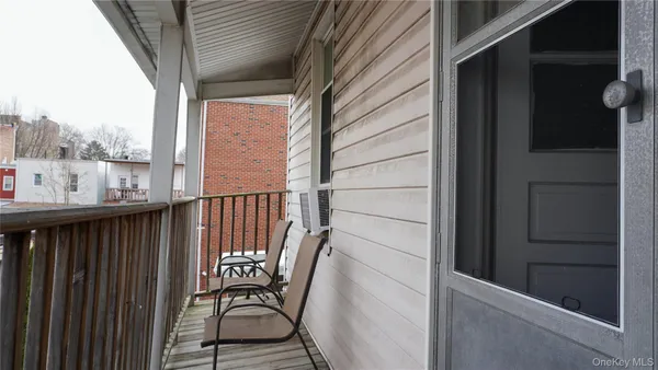 a view of a balcony with furniture and wooden deck