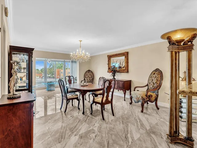 a view of a dining room with furniture wooden floor and a chandelier
