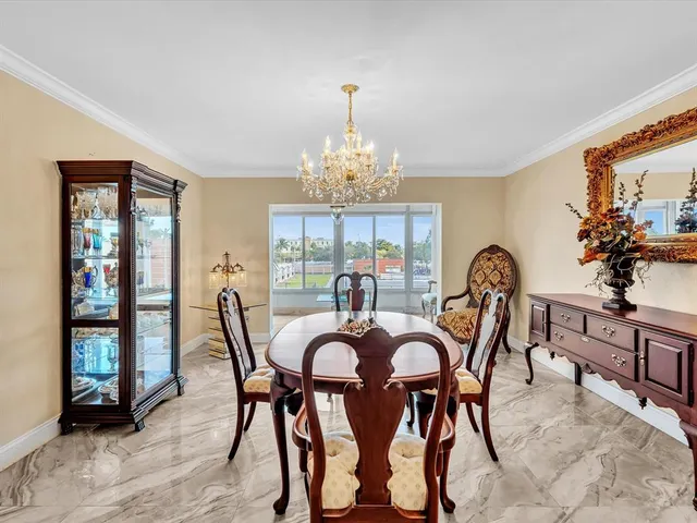a view of a porch with furniture and floor to ceiling window