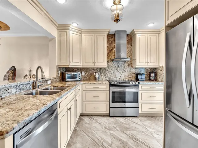 a living room with furniture a flat screen tv and a window