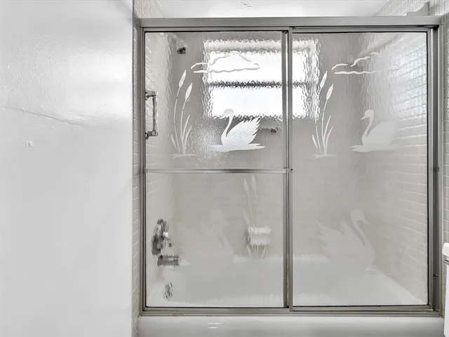a spacious bathroom with a granite countertop sink and a mirror
