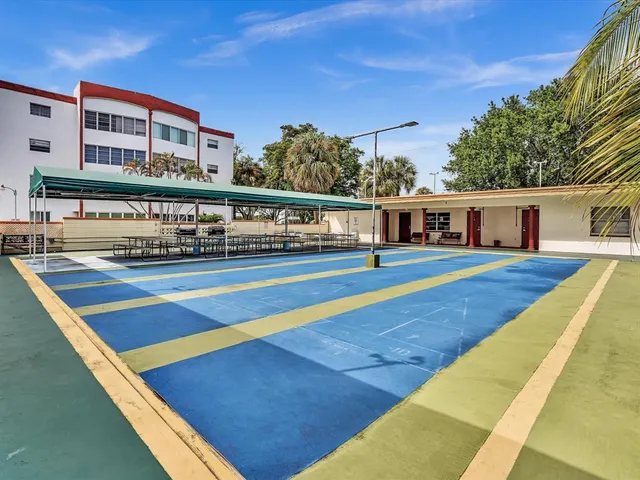 a room with pool table and windows