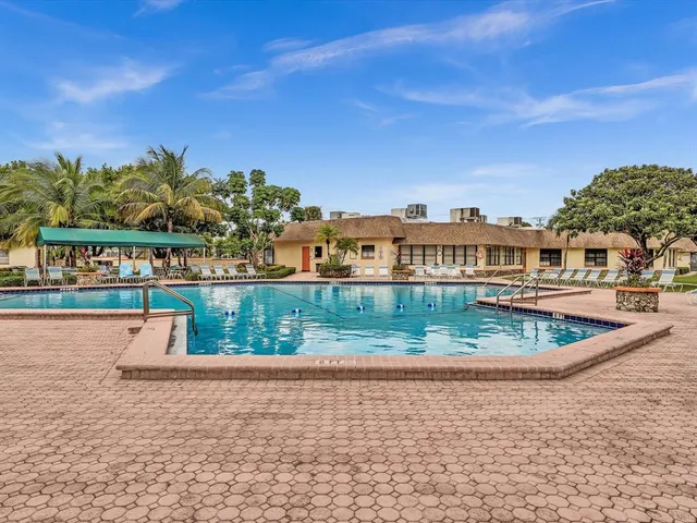 a room with pool table and windows
