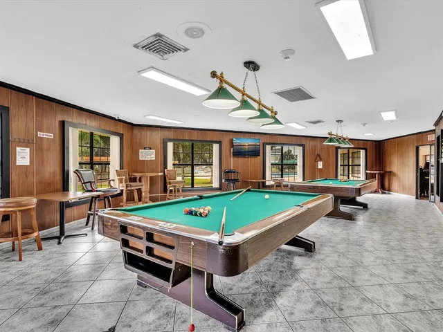 a room with lots of chairs and a large window