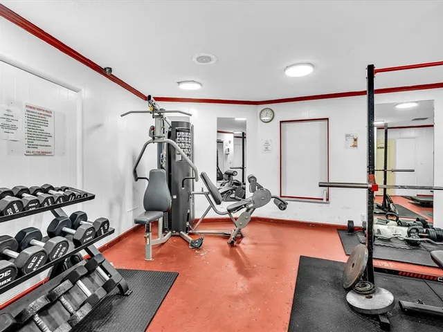 a view of a white house with a big yard and large trees