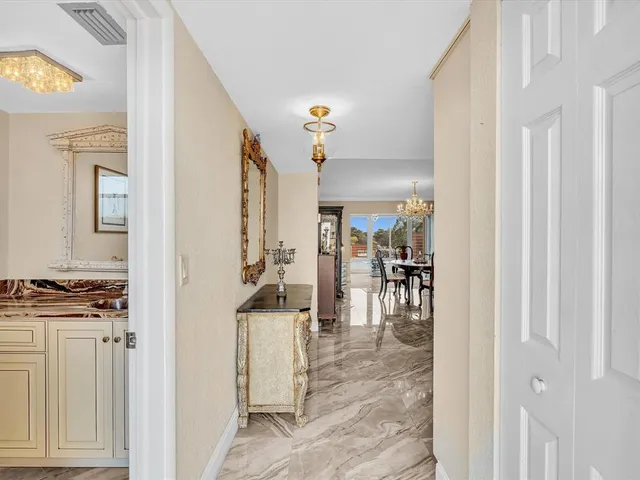 a kitchen with stainless steel appliances white cabinets and a refrigerator
