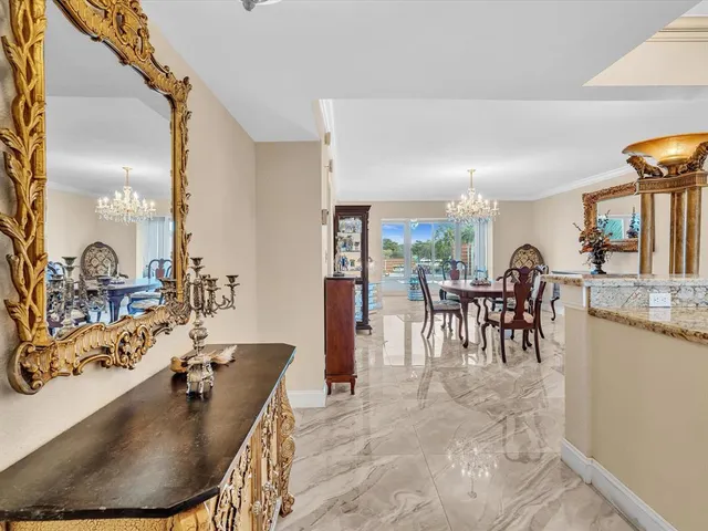 a kitchen with granite countertop white cabinets and stainless steel appliances