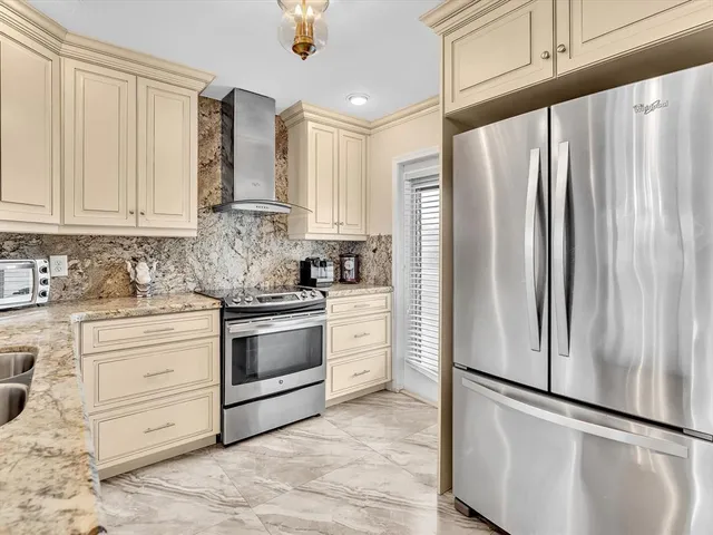 a view of a dining room with furniture and chandelier