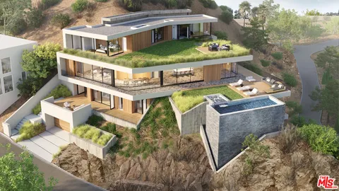 an aerial view of a house with a garden and swimming pool