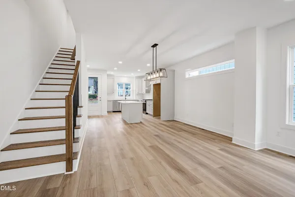a view of a room with wooden floor and stairs