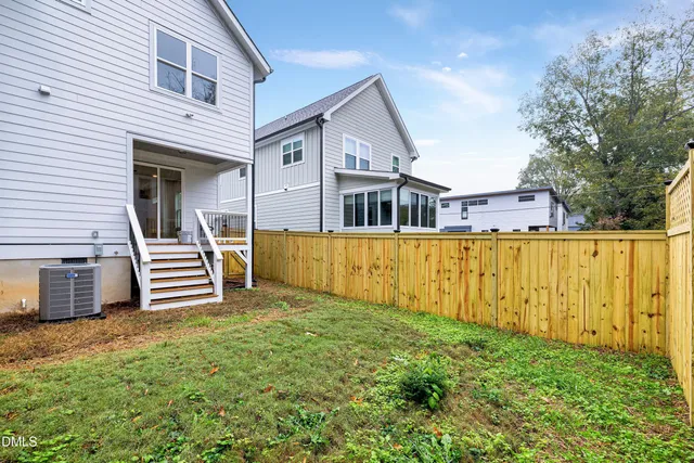 a front view of a house with glass windows and yard