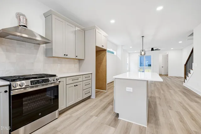 a kitchen with a stove a sink and a refrigerator