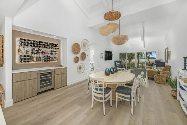 a kitchen with stainless steel appliances kitchen island granite countertop a table and chairs in it