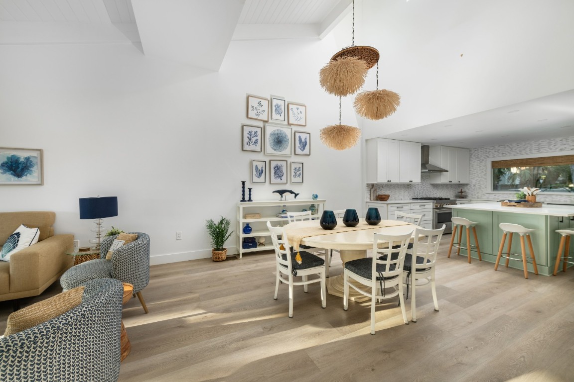 3422 Sea Marsh Road Fernandina Beach, FL 32034 - Photo 15 of 42 a view of a dining room and livingroom with furniture a rug a fireplace and a chandelier