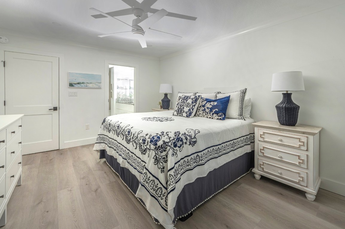 3422 Sea Marsh Road Fernandina Beach, FL 32034 - Photo 17 of 42 a bedroom with a bed and a chandelier