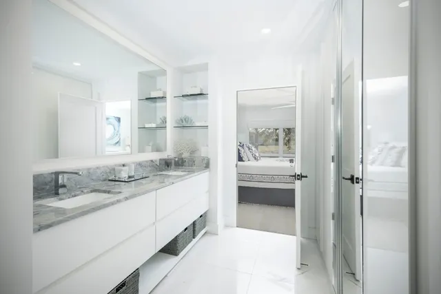 a bathroom with a granite countertop sink mirror and double