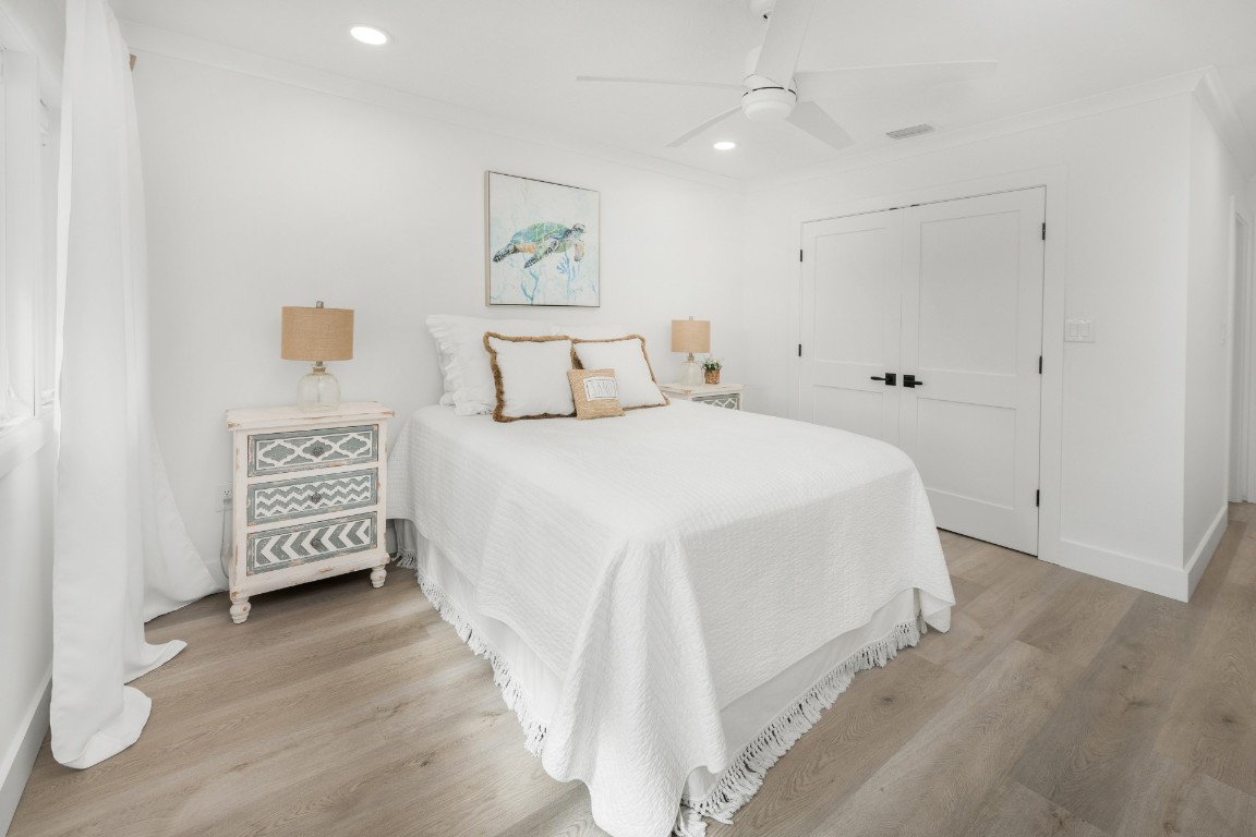 3422 Sea Marsh Road Fernandina Beach, FL 32034 - Photo 24 of 42 a spacious bedroom with a bed and a painting on the wall