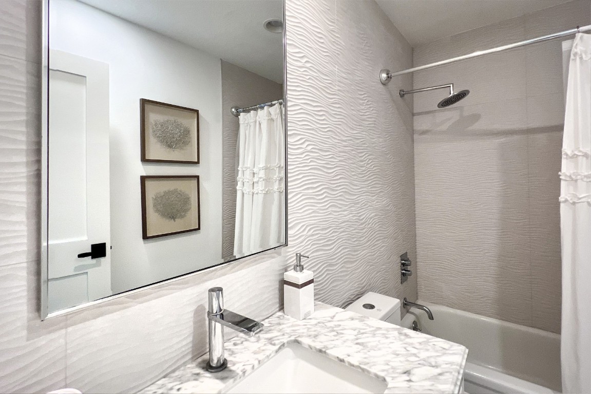 3422 Sea Marsh Road Fernandina Beach, FL 32034 - Photo 27 of 42 a bathroom with a granite countertop sink a mirror and shower