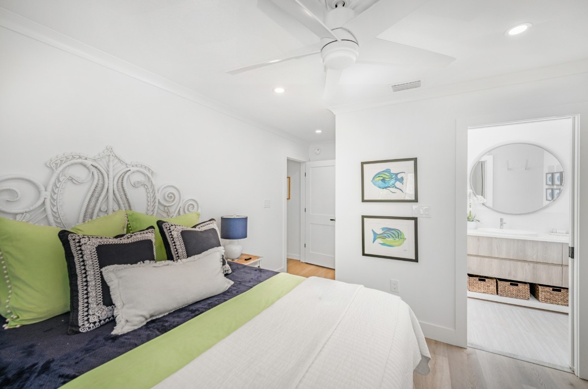 3422 Sea Marsh Road Fernandina Beach, FL 32034 - Photo 30 of 42 a bedroom with a bed and a chandelier