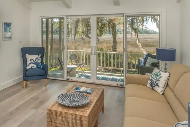 a living room with furniture and a floor to ceiling window