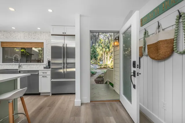 a kitchen with stainless steel appliances granite countertop a refrigerator and a sink