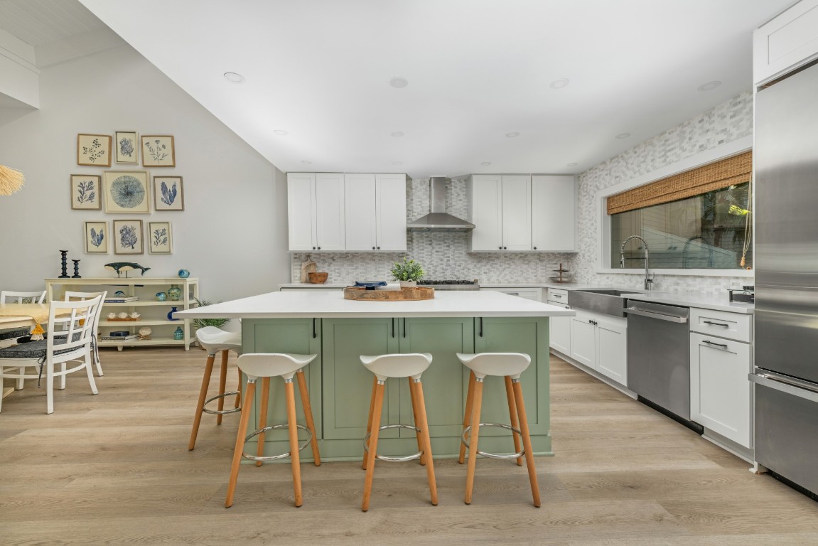 3422 Sea Marsh Road Fernandina Beach, FL 32034 - Photo 10 of 42 a kitchen with stainless steel appliances granite countertop a stove top oven a sink a dining table and chairs