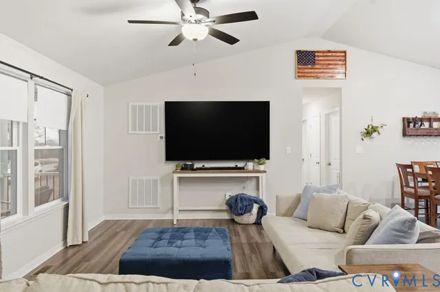 a living room with furniture and kitchen view
