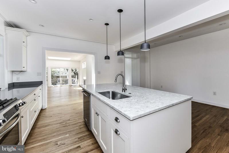 3222 Klingle Road Northwest Washington, DC 20008 - Photo 11 of 46 a kitchen with a sink dishwasher and wooden floor