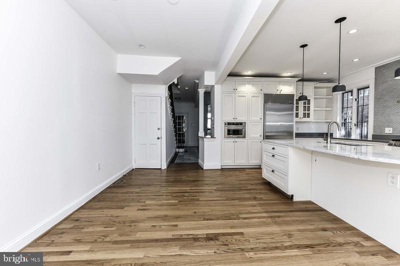3222 Klingle Road Northwest Washington, DC 20008 - Photo 15 of 46 a large kitchen with cabinets and wooden floor