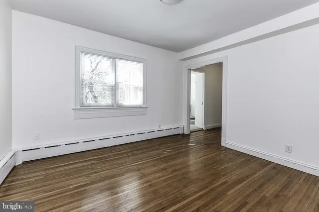 a bathroom with a tub sink toilet and a window