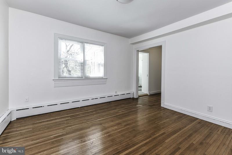 3222 Klingle Road Northwest Washington, DC 20008 - Photo 17 of 46 an empty room with wooden floor and windows
