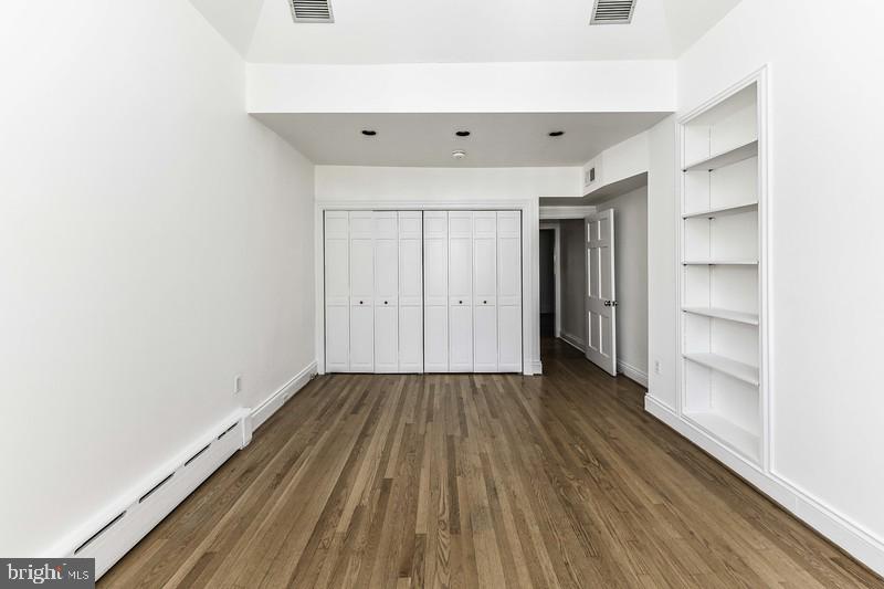 3222 Klingle Road Northwest Washington, DC 20008 - Photo 25 of 46 a view of an empty room with wooden floor