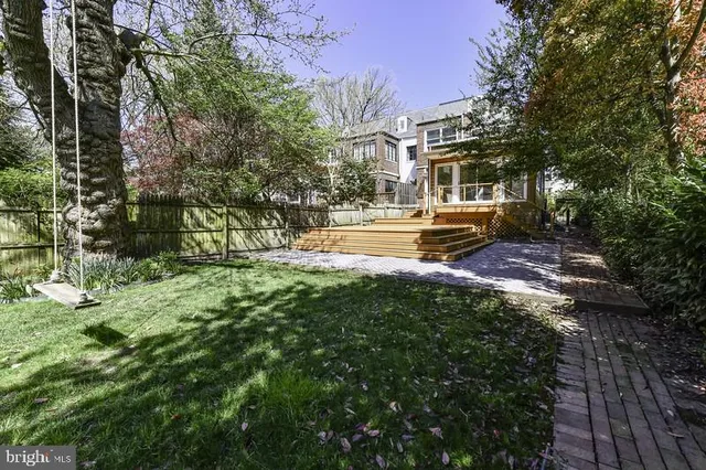 a view of a chairs and table in backyard