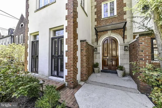 a front view of a house with a yard and potted plants