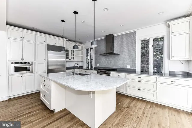a kitchen with a sink stove and cabinets