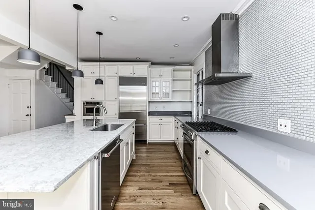 a kitchen with a sink stove and cabinets