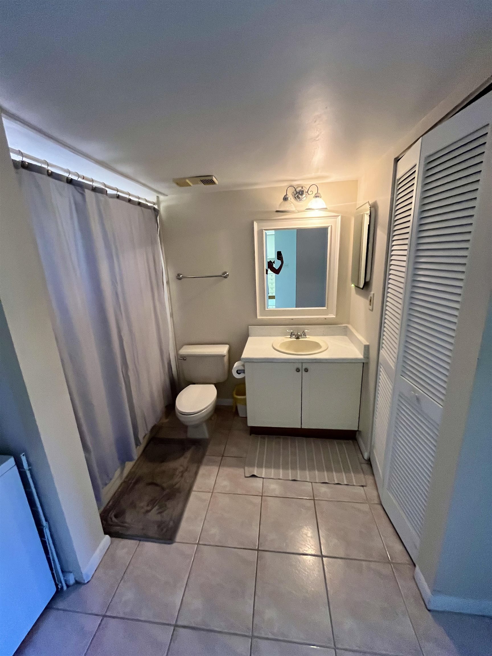 4250 A1A South, Unit C12 St. Augustine, FL 32080 - Photo 11 of 15 a bathroom with a sink a toilet and a mirror