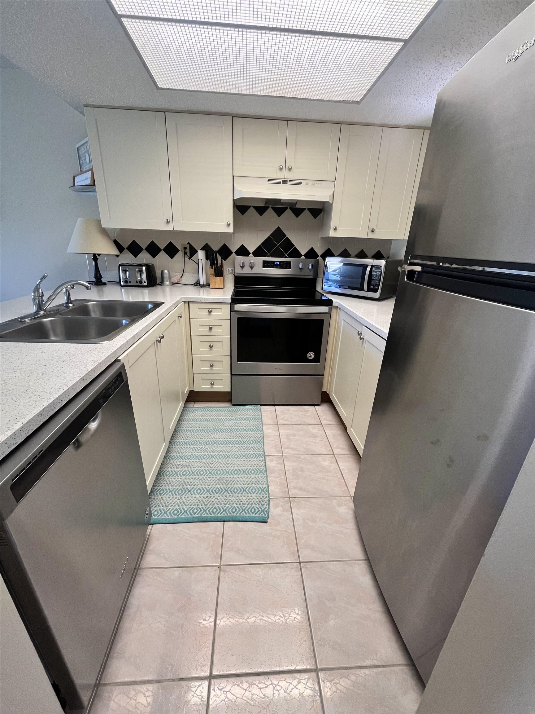 4250 A1A South, Unit C12 St. Augustine, FL 32080 - Photo 4 of 15 a kitchen with a sink a stove and cabinets