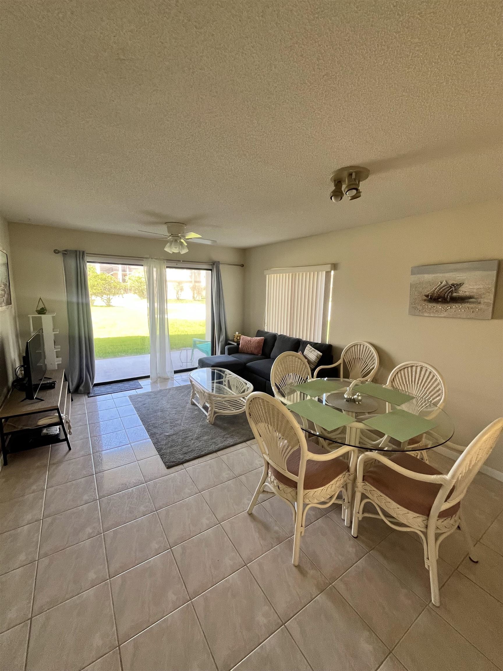 4250 A1A South, Unit C12 St. Augustine, FL 32080 - Photo 5 of 15 a living room with chairs and a table with wooden floor