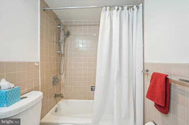 a bathroom with a shower curtain and a sink