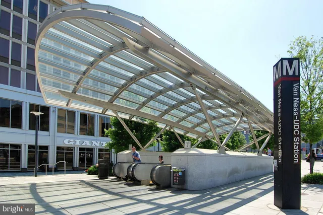 a front view of multi story commercial building with retail shops