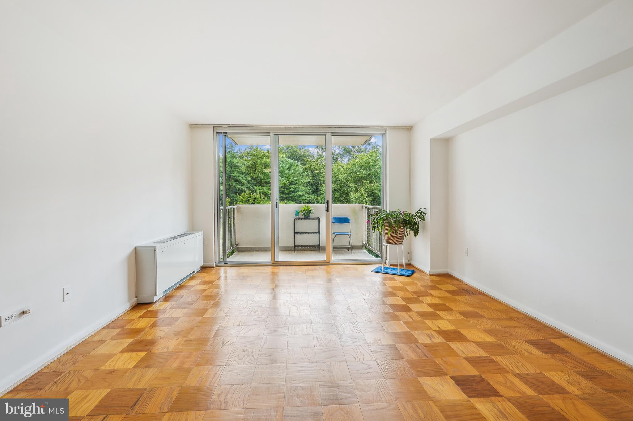 2939 Van Ness Street Northwest, Unit 630 Washington, DC 20008 - Photo 6 of 25 a view of an empty room with wooden floor and a window