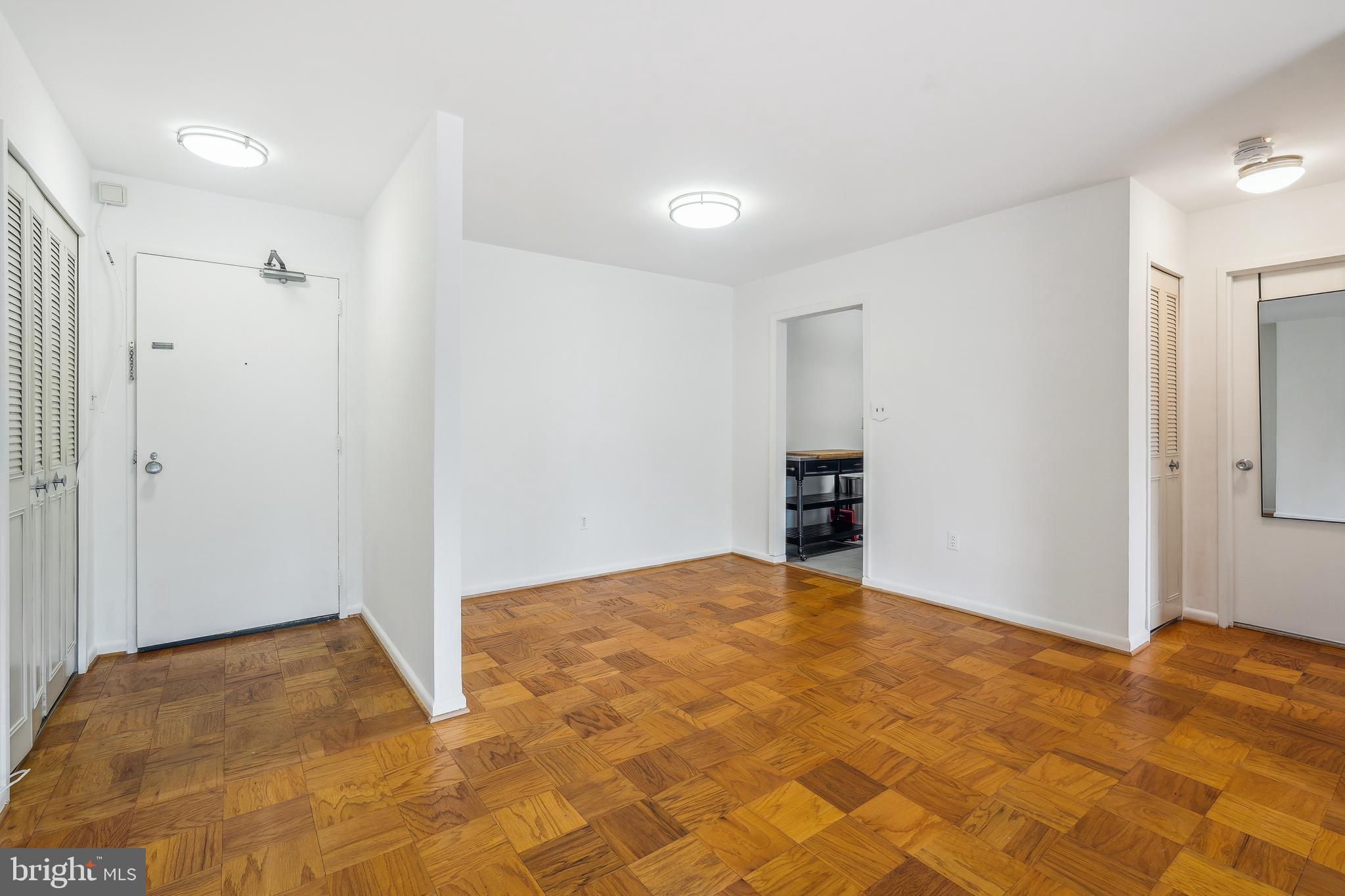 2939 Van Ness Street Northwest, Unit 630 Washington, DC 20008 - Photo 8 of 25 a view of an empty room with kitchen and a window