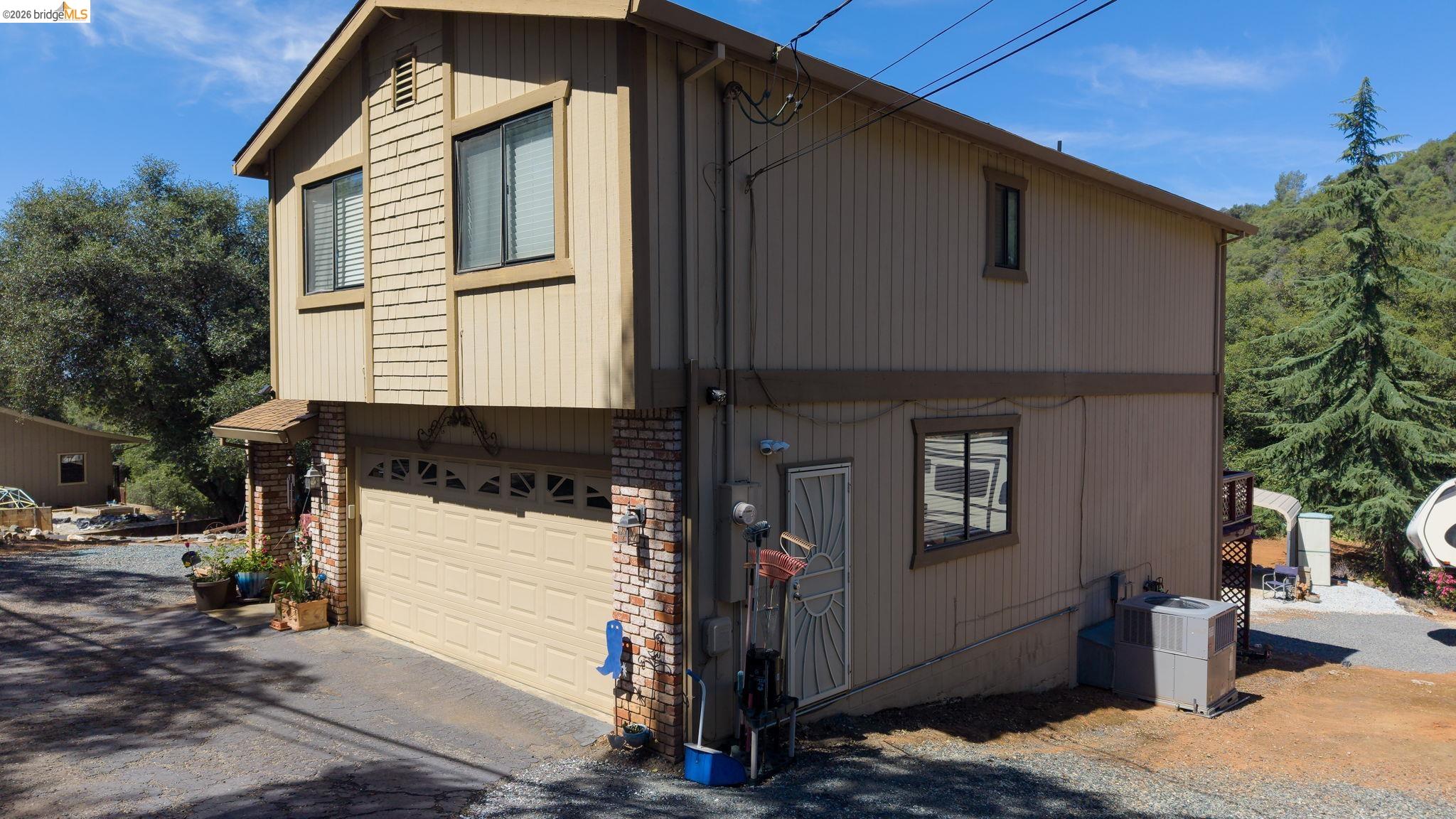 11858 Campo Seco Road Sonora, CA 95370 - Photo 5 of 45 Two-story residence featuring a two-car garage with an overhead door