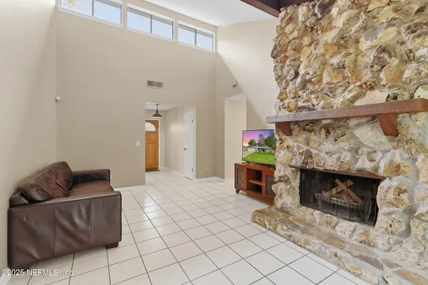 a living room with furniture and a fireplace